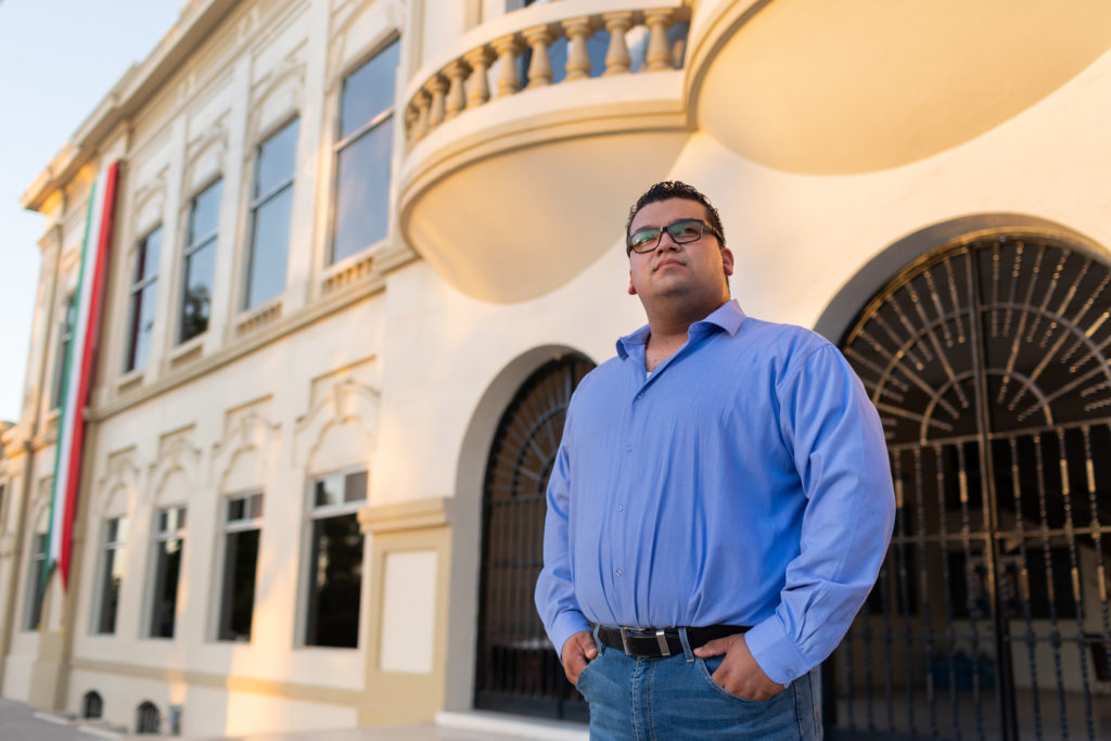 Christian in front of a building