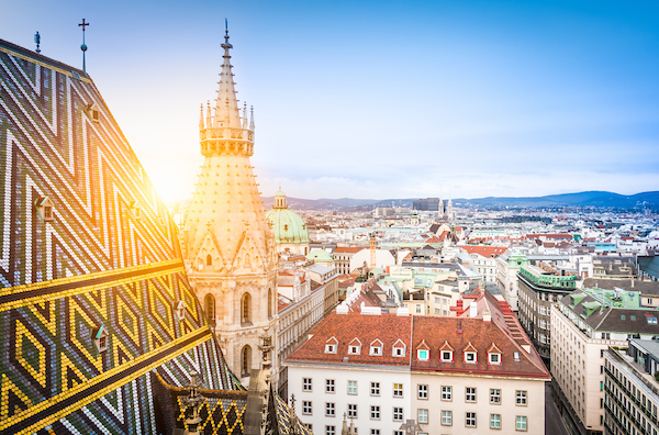 Aerial view over the rooftops of Vienna from the north tower of St. Stephen's Cathedral including the cathedral's famous ornately patterned richly colored roof created by 230000 glazed tiles Austria