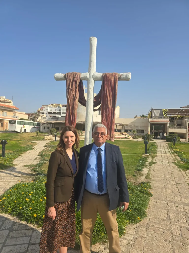 Lizzie Francis Brink in Egypt in front of a cross.