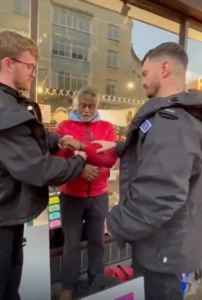 Photo of Pastor Dia arrested in handcuffs for peaceful preaching.